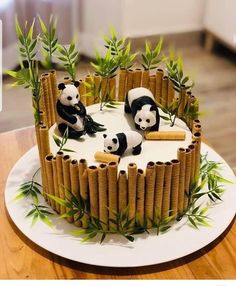 a cake decorated with bamboo sticks and panda bears