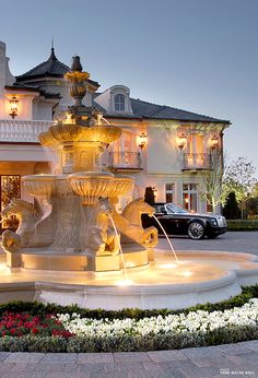 a fountain in front of a large white building