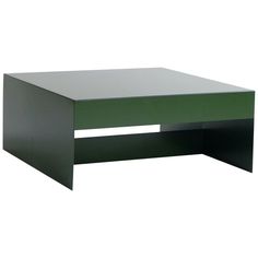 a green coffee table sitting on top of a white floor