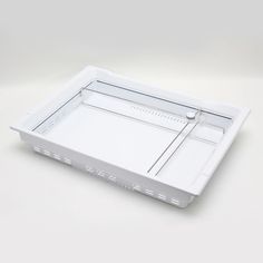 an empty white tray on a plain surface