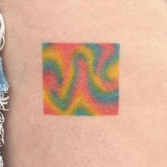 a woman's arm with a colorful pattern on the left side of her body