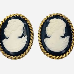 Large And In Charge, These Vintage Clip Earrings From Jay Feinberg Feature Molded Lucite Cameos In Black And White. The Cameo Has A Lovely Face With Upswept Hair And A Flower Corsage. The Earrings Are Framed With Braided Metal Chain In Antique Gold Tone. These Earrings Are Quite Impressive Measuring 1 3/4 By 1 3/8” But Lightweight And Very Comfortable To Wear. Signed Jay Feinberg. Elegant Cameo Clip-on Earrings Gift, Formal Cameo Yellow Gold Earrings, Classic Cameo Earrings, Gold Cameo Vintage Earrings, Collectible Black Cameo Jewelry, Vintage Clip Earrings, Cameo Earrings, Flower Corsage, Vintage Clip