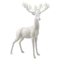 a white deer figurine with lights on its antlers