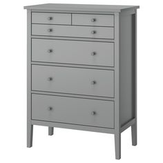 a gray chest of drawers with four drawers