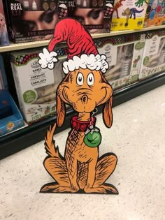 a cartoon dog with a santa hat on it's head in a store aisle