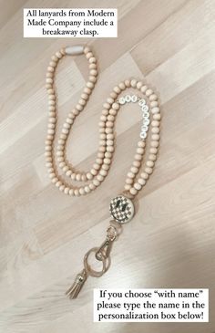 a wooden beaded necklace with a keychain on it