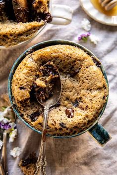 a close up of a dessert in a bowl on a table with two spoons