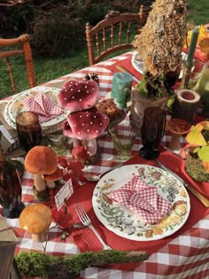 the table is set with plates and mushrooms