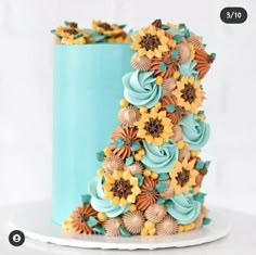 a blue cake with sunflowers on it