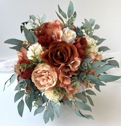 a bridal bouquet with flowers and greenery on the top is ready to be used as a wedding bouquet