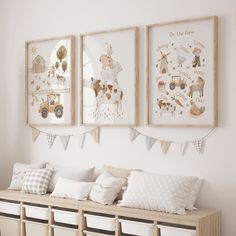 three framed pictures hang on the wall above a wooden bench with storage baskets underneath it