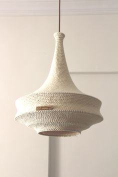 a white light fixture hanging from a ceiling