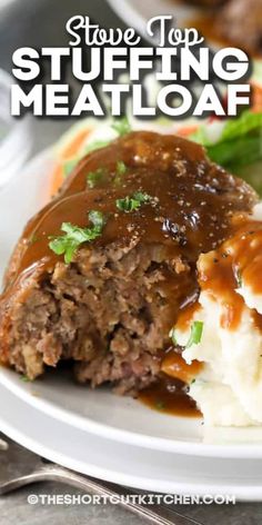 a white plate topped with meatloaf covered in gravy