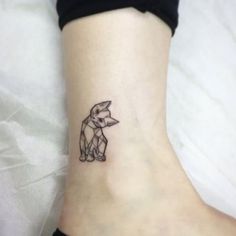 a small tattoo on the ankle of a woman's foot, depicting an elephant