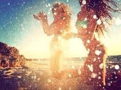 two women standing on the beach in the snow