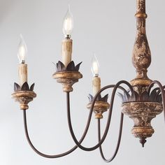 a chandelier with five candles hanging from it's arms and four lights on each end