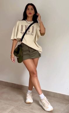 Green mini cargo skirt outfit inspiration. Casual outfits ideas for girls. Beige oversized t-shirt, military green mini cargo skirt and white sneakers outfit inspiration. Street style outfits ideas for girls. Chic style outfit ideas. #casual #fashion #ootd #style #outfits #grwm #streetstyle #outfitideas #streetwear Green Skirt Outfits, Cargo Skirt Outfit, Fall Ootd, Luxury Photography, Text Story, Outfit Streetwear, Skirt And Sneakers, Miniskirt Outfits, Classy Fashion