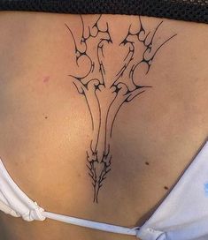 a woman's lower back tattoo with flowers on it