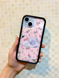 a person holding up a phone case with a swan on the front and flowers on the back