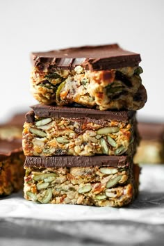 three bars stacked on top of each other with nuts and seeds in them, next to one another