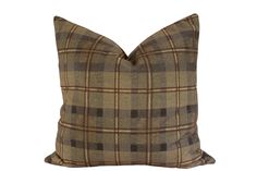 a brown plaid pillow on a white background