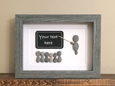 a frame with rocks and a chalkboard saying your text here