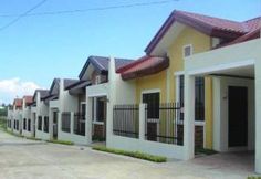 a row of houses with white and yellow walls