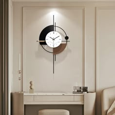 a clock that is on the side of a wall next to a desk and chair