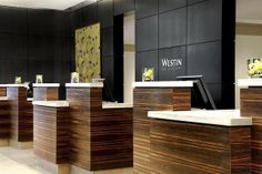 the front desks are lined up against the wall in this modern office building with black walls and wood paneling