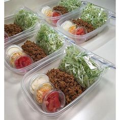 some plastic containers filled with food on top of a table