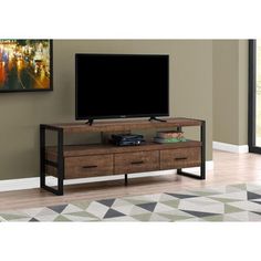 a flat screen tv sitting on top of a wooden entertainment center in a living room