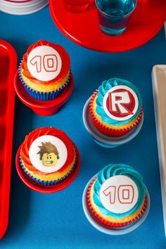 some cupcakes are sitting on a blue table