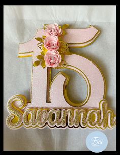 a pink and gold birthday cake topper with flowers on it's number six