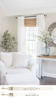 a living room with white furniture and curtains