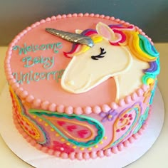 a birthday cake decorated with an unicorn face