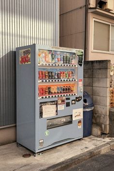 a vending machine sitting next to a building