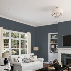 a living room filled with furniture and a flat screen tv mounted on the wall above a fireplace