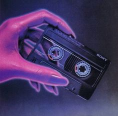 a hand holding an old fashioned cassette in front of a purple and blue background with the word sony on it