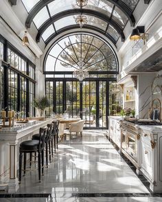 a large kitchen with an arched ceiling and marble floors