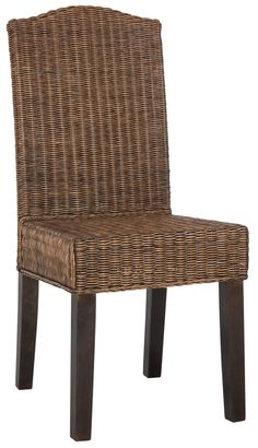 a brown wicker chair sitting on top of a wooden table