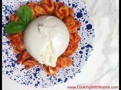 a blue and white plate topped with macaroni and cheese covered in sour cream