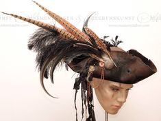 + + + Steampunk - Pirate Hat + + + The hat is made of aged premium wool felt. It is adorned with feathers of pheasants, roosters and ostriches, as well as gear wheels and buttons. The hat is available in sizes between: 54 & 64 Size -> circumference of your head in cm Shipping info: If you live in the US or Canada, I highly recommend premium airmail shipping. Depending on the current offer, we try to find an even better option for each selected shipping method. Express shipping is possible on req Pirate Bride, Mermaid Headdress, Pirate Halloween Party, Captain's Hat, Feathered Hat, Historical Hats, Steampunk Pirate, Pirate Hat, Pirate Hats