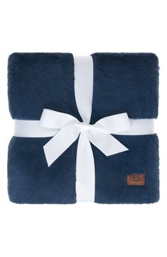 a blue and white blanket with a bow on it's end, wrapped in a ribbon