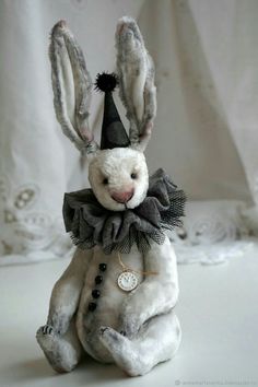 a white stuffed rabbit wearing a party hat