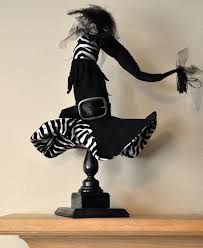 a black and white dress on a mannequin with zebra print skirt, gloves and hair