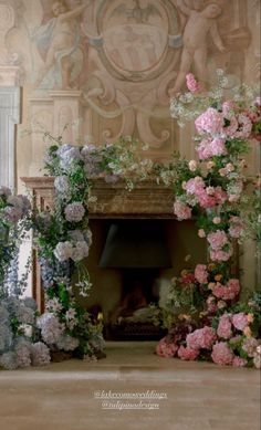 an ornate fireplace decorated with pink and white flowers