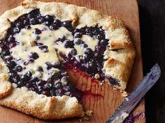 a blueberry cheesecake is cut into slices