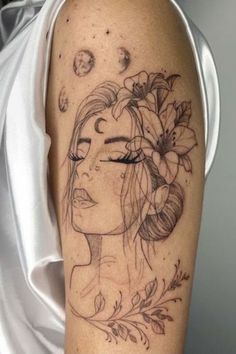 a woman's face with flowers and planets on her head is shown in this tattoo design