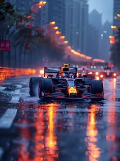 a red bull racing car driving down the street in the rain with its lights on