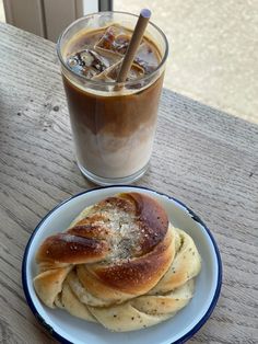 a plate with some food on it next to a cup of coffee and a drink